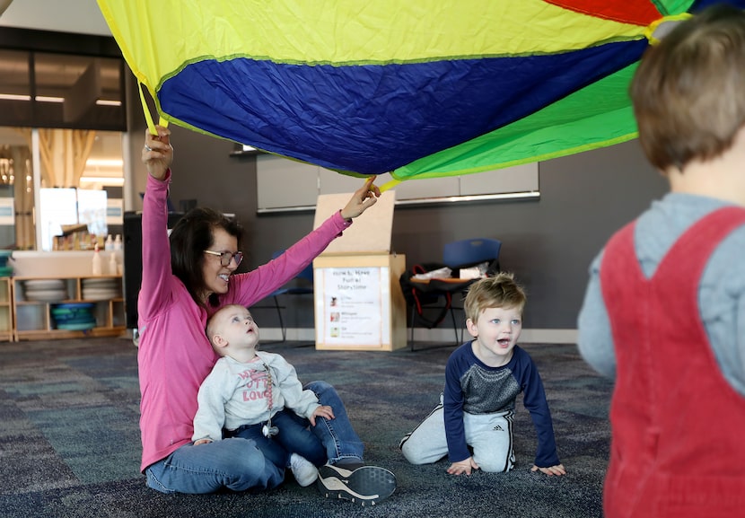 Michele Pahl plays with her grandchildren Fitz, 3, and Olsen, 14 months old, during Toddler...