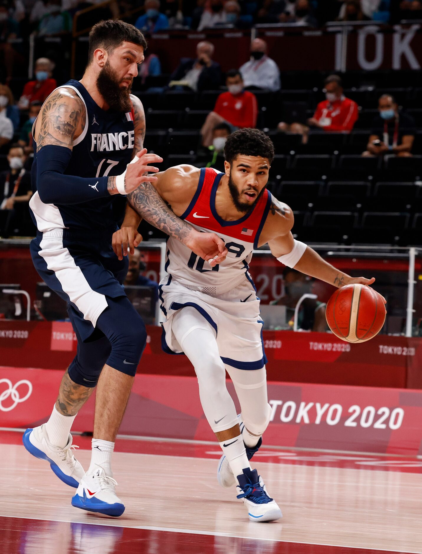 USA’s Jayson Tatum (10) drives on France’s Vincent Poirier (17) during the first half of...