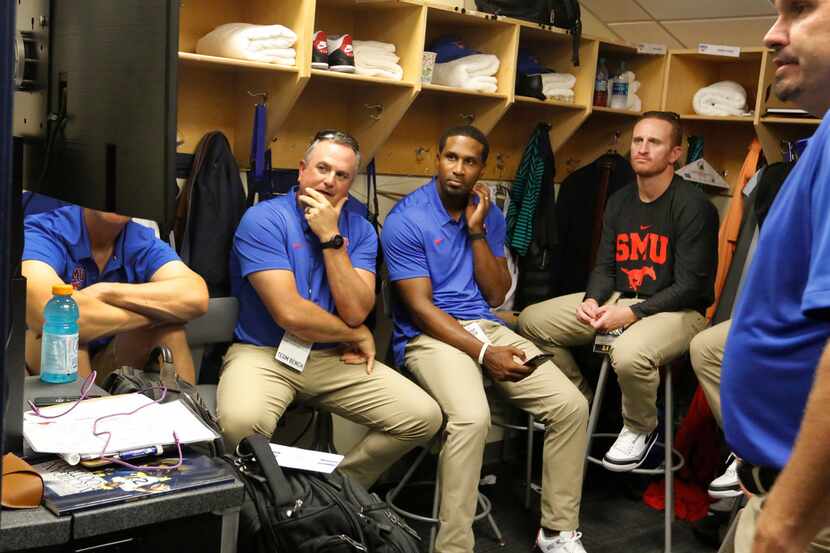 FILE - SMU head coach Sonny Dykes watches film with his assistants in the cramped coaches...