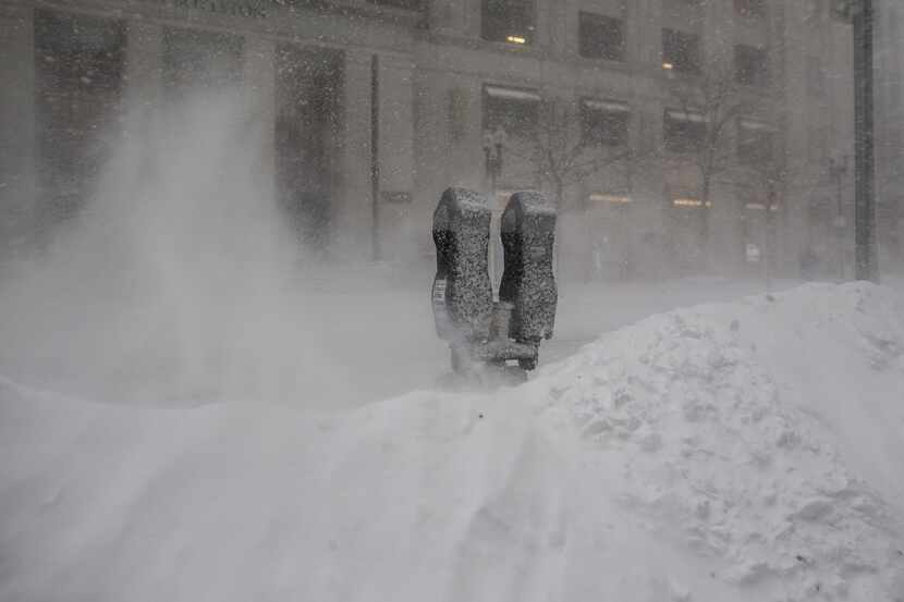 Snow blows around parking meters as a winter storm bears down on February 9, 2017 in Boston,...