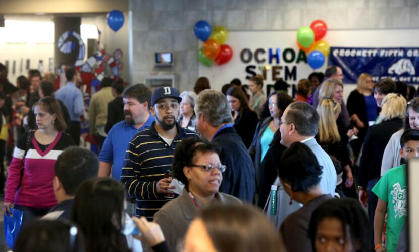 Parents and students look at different career path education during an open house at Dubiski...