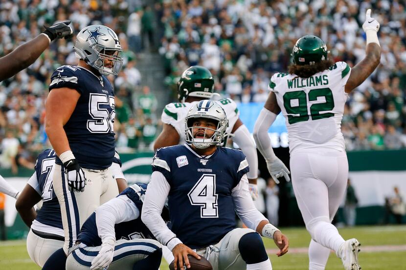 Dallas Cowboys quarterback Dak Prescott (4) gets back to his feet after being stopped short...