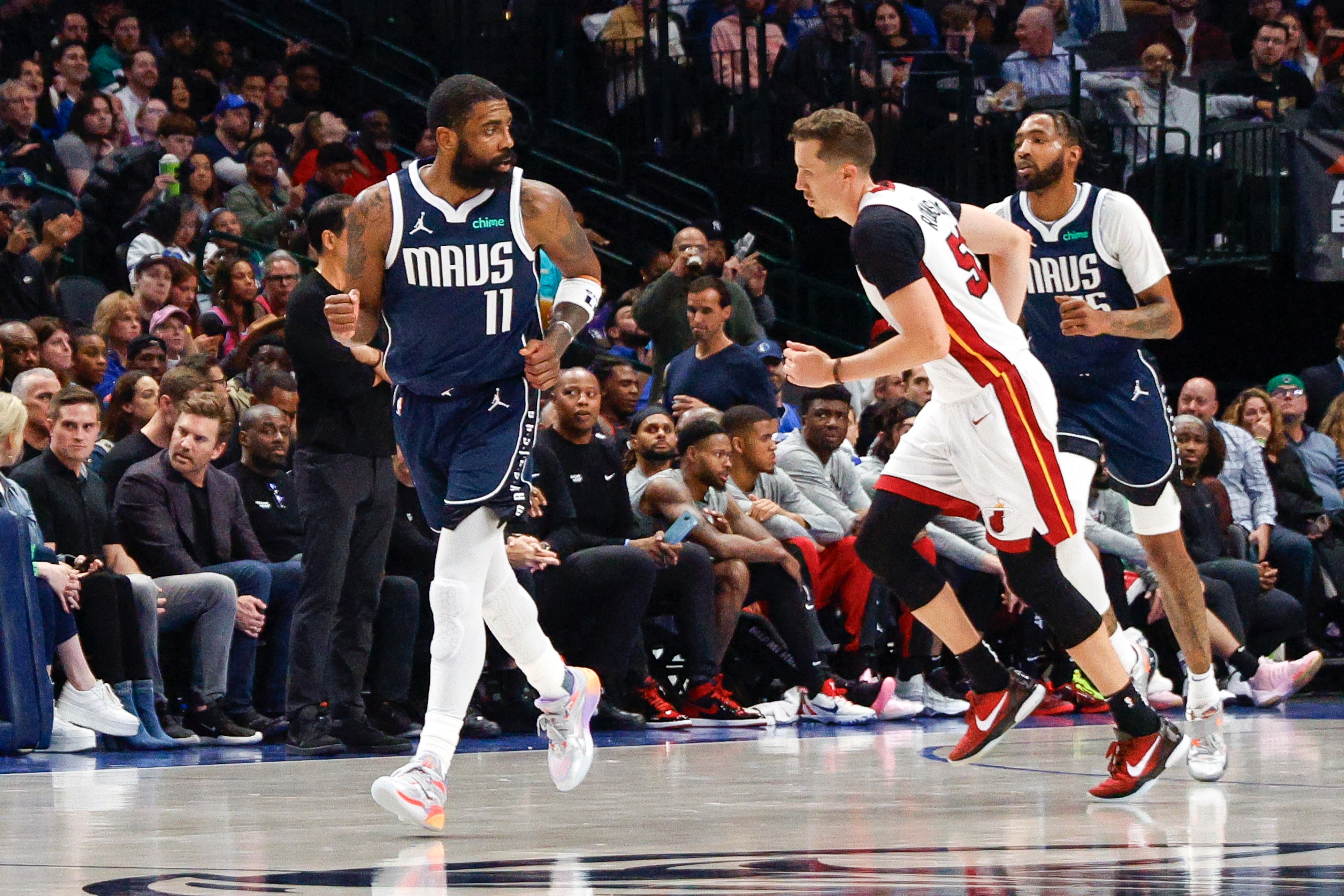 Dallas Mavericks guard Kyrie Irving (11) reacts after making a three-pointer during the...