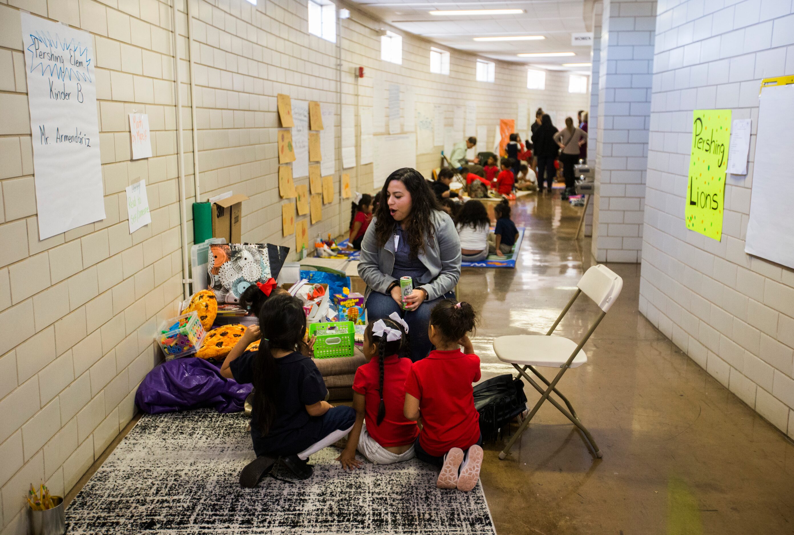 Tania Fuentes, an instructional specialist, helps a Pershing Elementary kindergarten class...