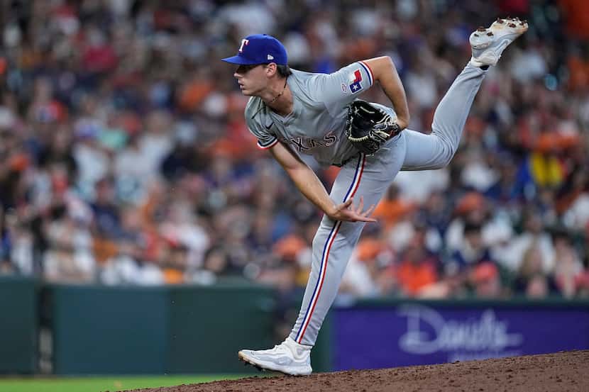 Texas Rangers relief pitcher Cole Winn delivers during the eighth inning of a baseball game...