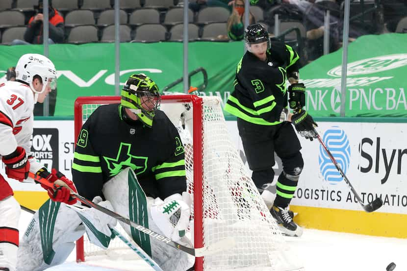 Dallas Stars defenseman John Klingberg (3) retrieves the puck as Dallas Stars goaltender...