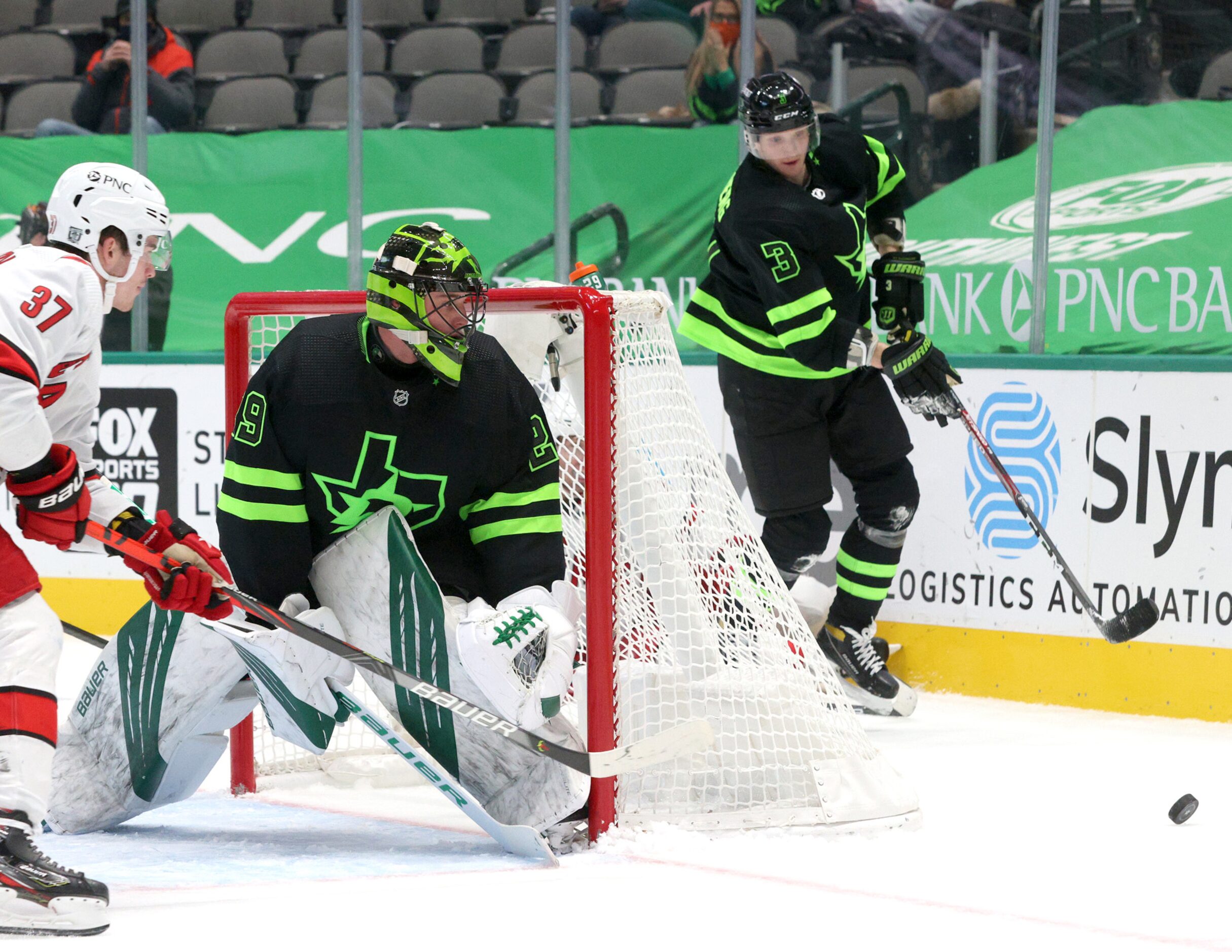 Dallas Stars defenseman John Klingberg (3) retrieves the puck as Dallas Stars goaltender...