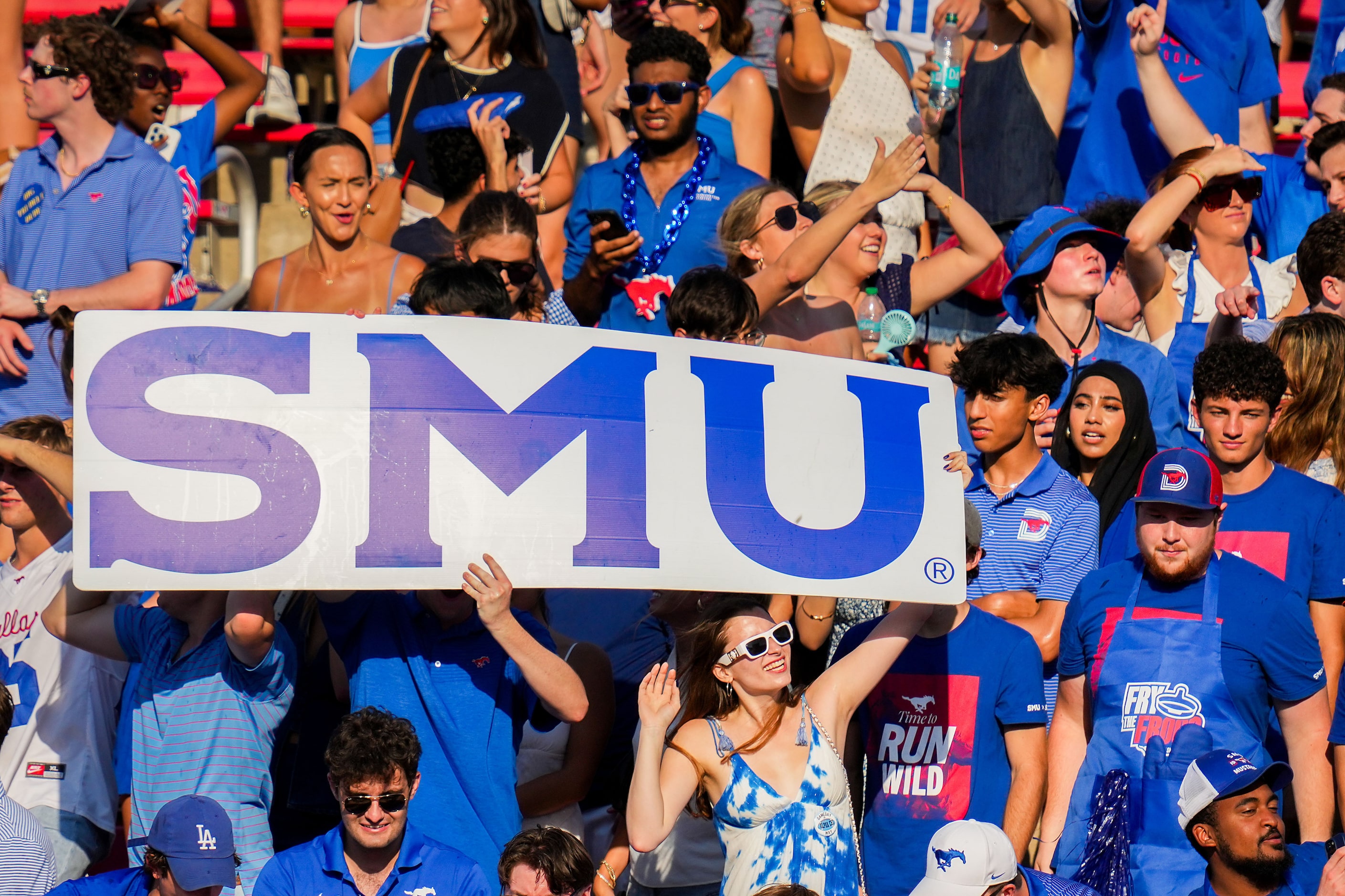 SMU fans cheer their team during the first half of an NCAA football game against TCU at Ford...