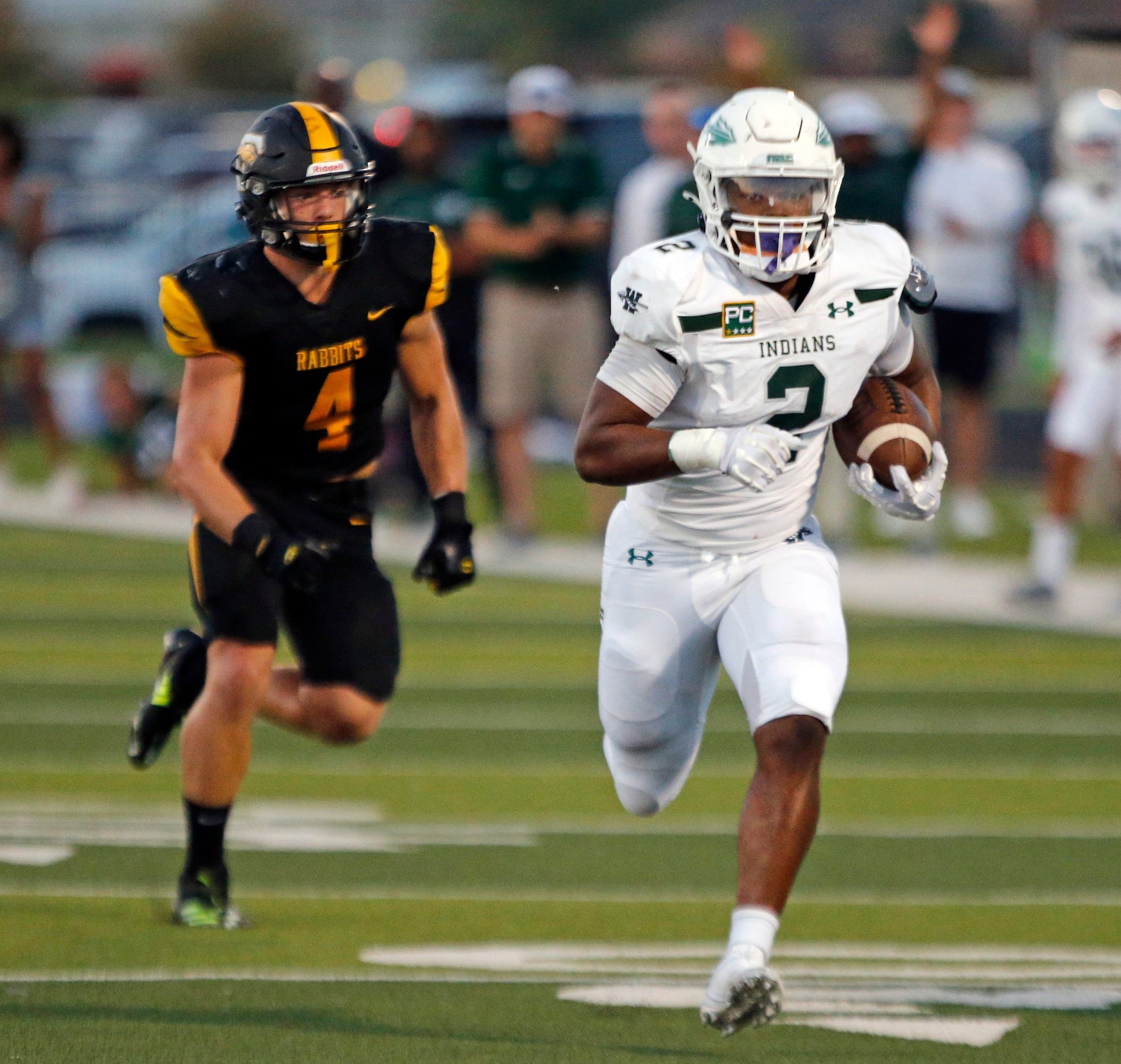 Waxahachie RB Wade Lemons (2) is chased by Forney high defender Landry Hopkins (4) in route...