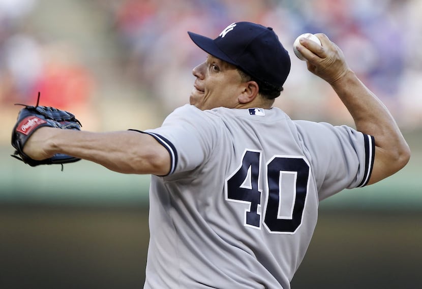 New York Yankees starting pitcher Bartolo Colon (40) pitches against the  Texas Rangers at...