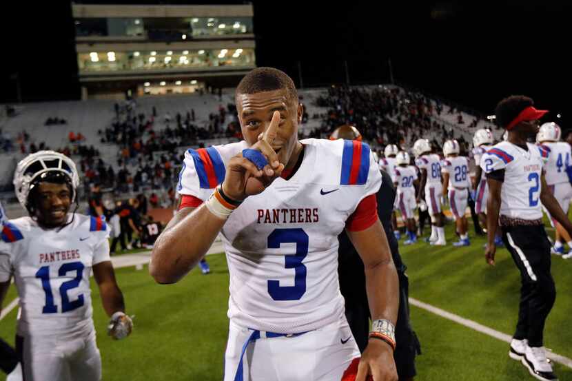 Duncanville quarterback Ja'Quinden Jackson flashes a number 1 after he and his teammates...