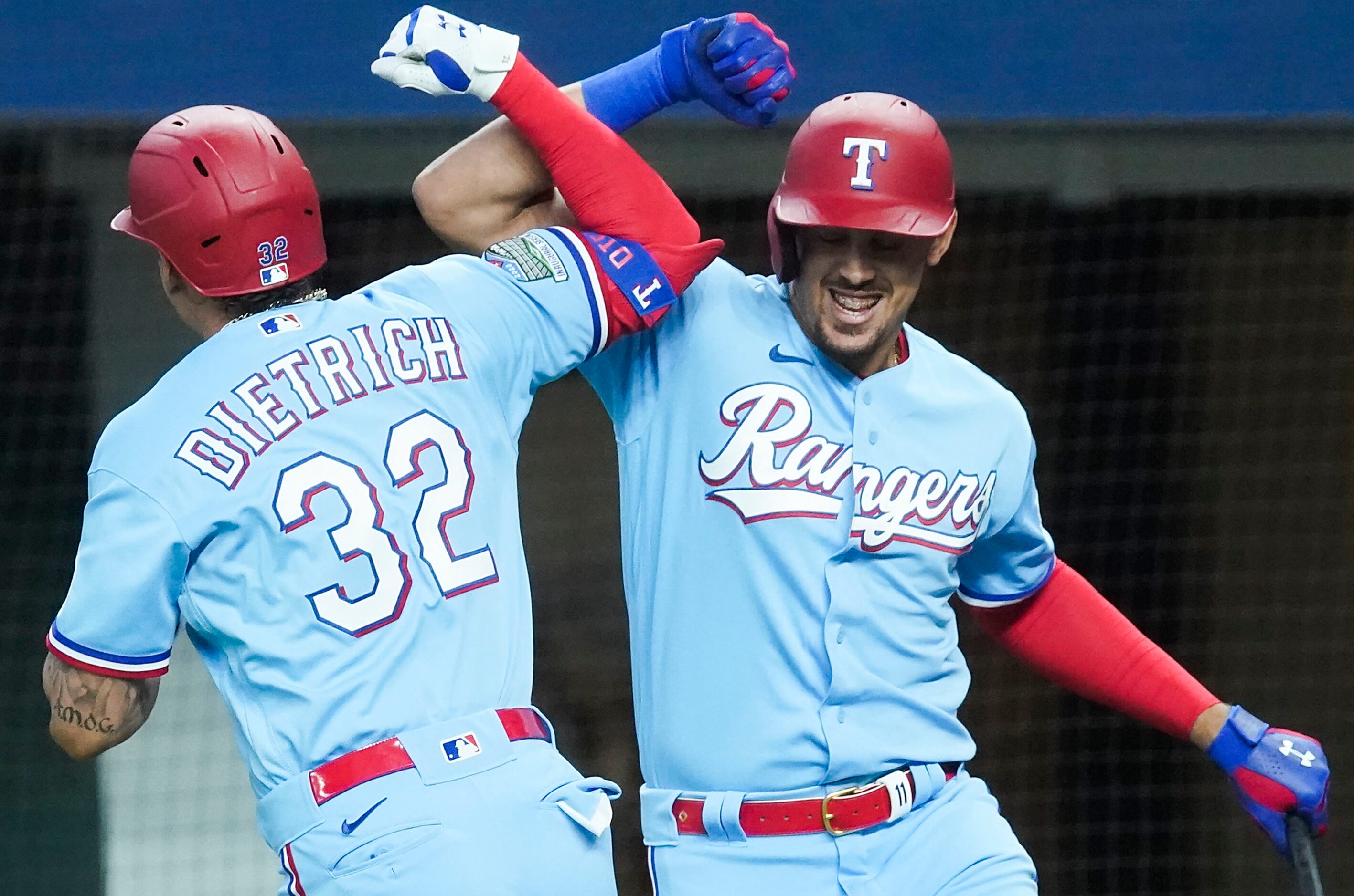 Texas Rangers designated hitter Derek Dietrich celebrates first baseman Ronald Guzman after...