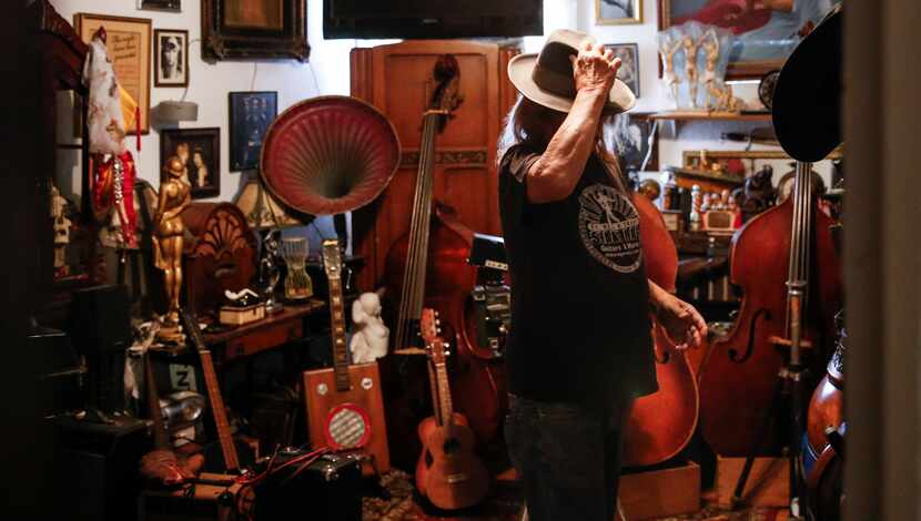 John Gasperik, a lifelong music memorabilia collector tries on a hat ahead of a portrait...