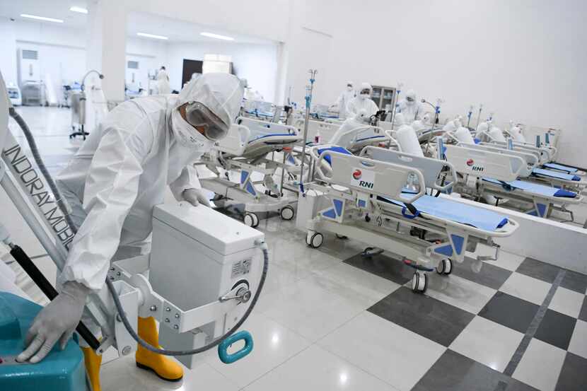 Staff inspect medical equipments at an emergency hospital set up amid the new coronavirus...