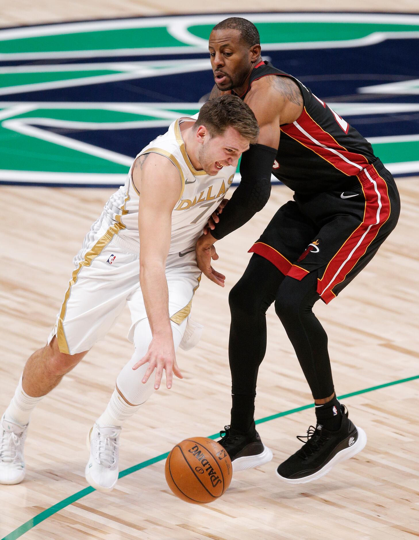 Dallas Mavericks guard Luka Doncic (77) battles Miami Heat guard Andre Iguodala (28) for...