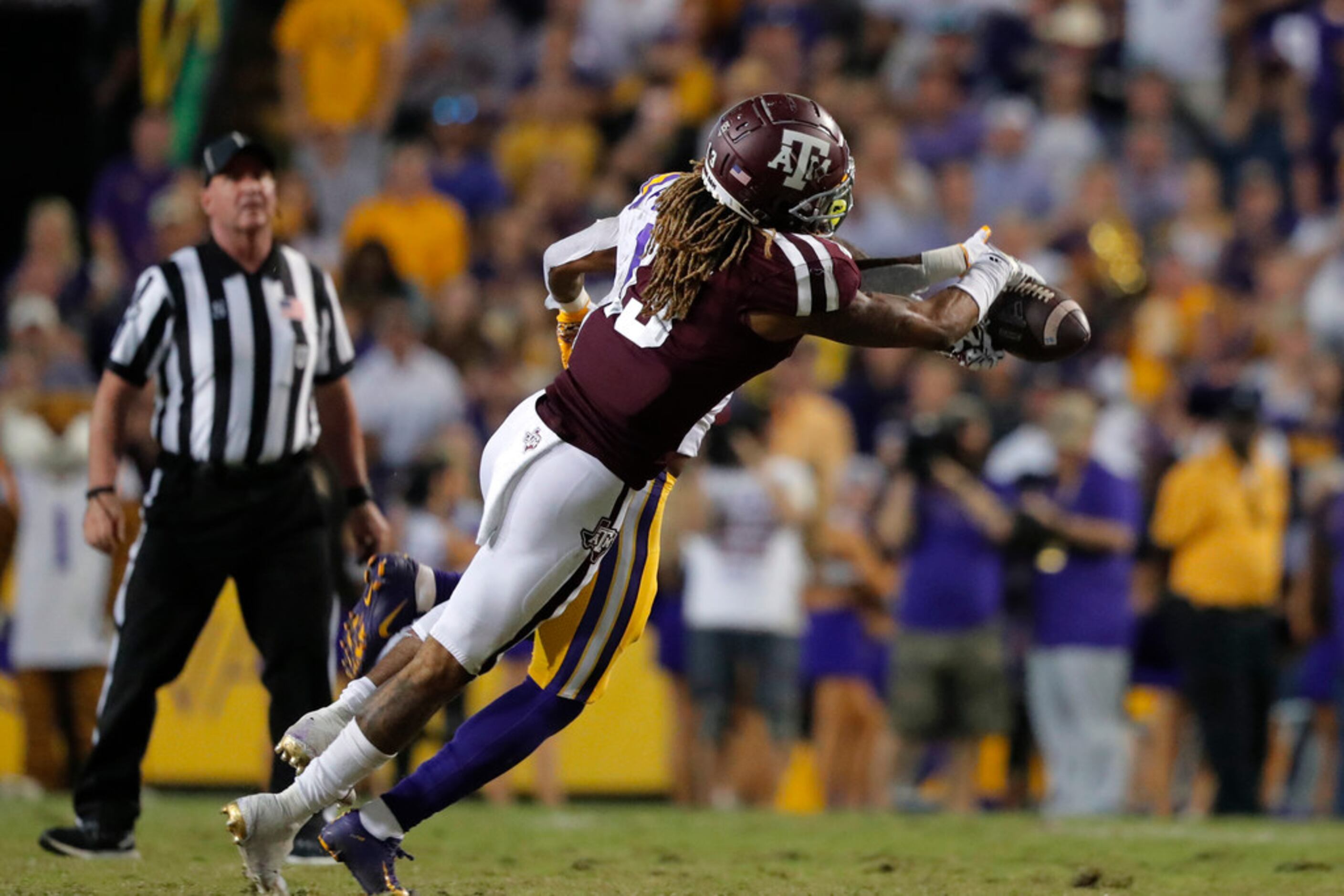 Texas A&M wide receiver Kendrick Rogers (13) tries to pull in a pass as he is defended by...