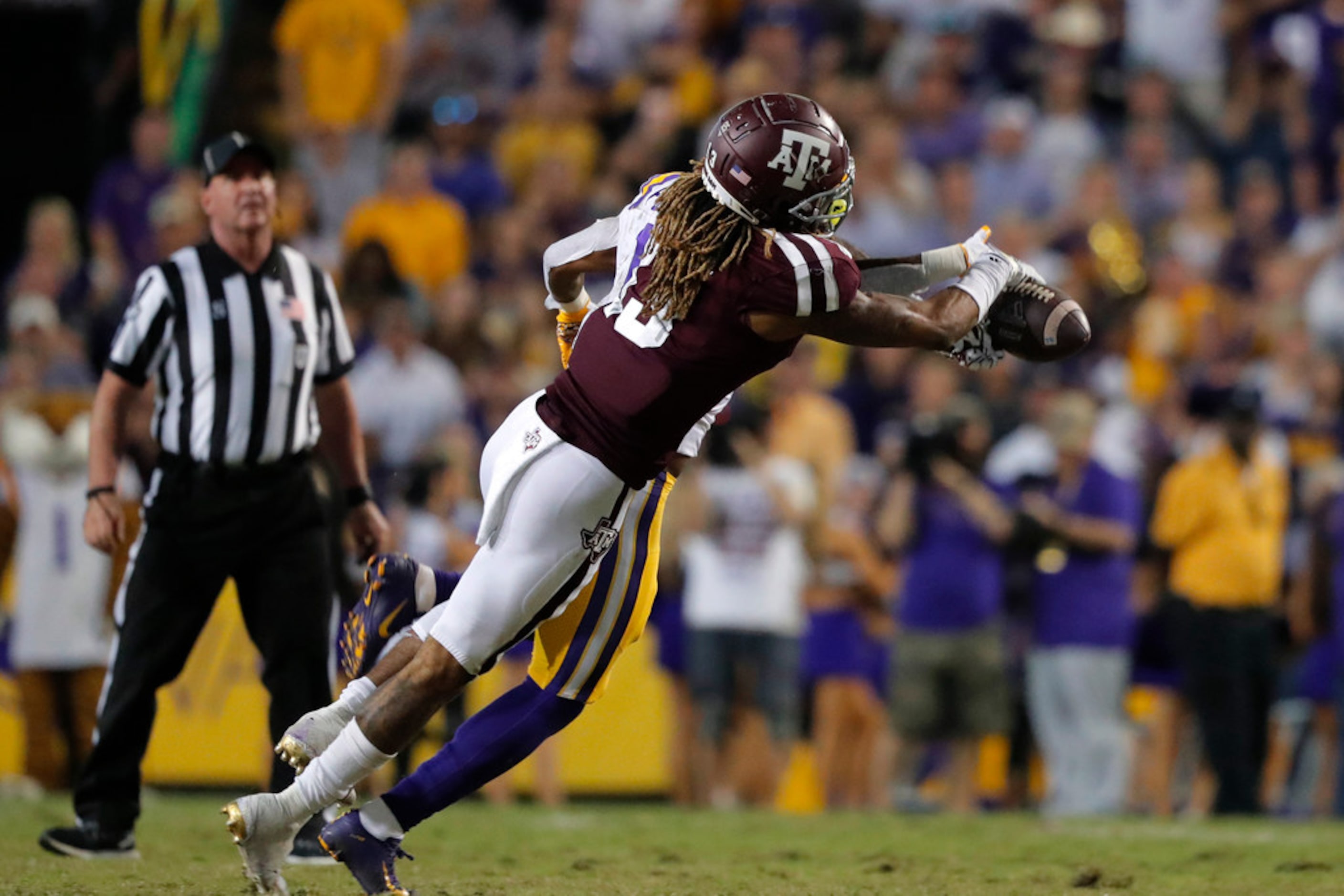 Texas A&M wide receiver Kendrick Rogers (13) tries to pull in a pass as he is defended by...