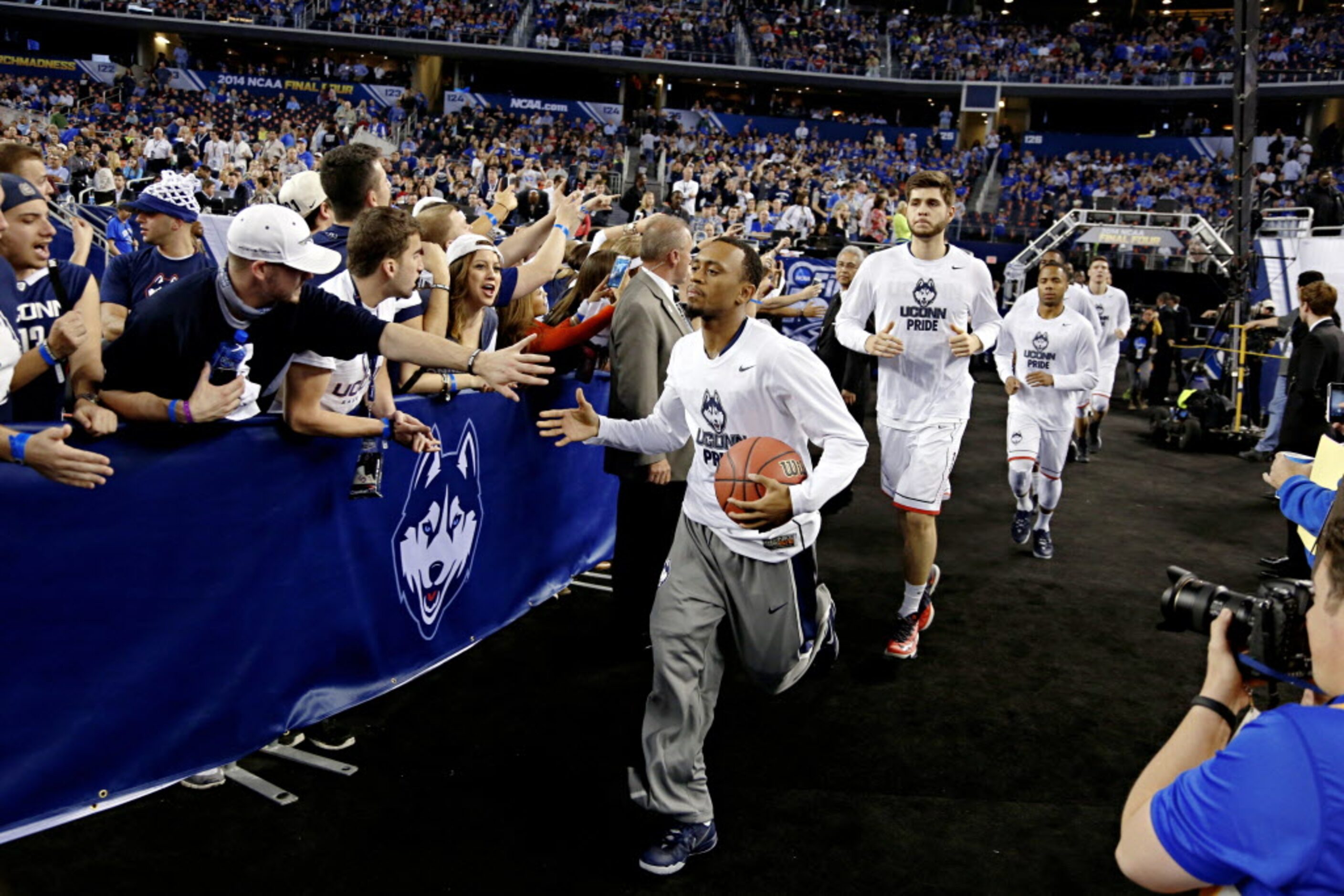 Fans cheer as the Connecticut Huskies take to the court before their NCAA Final Four...