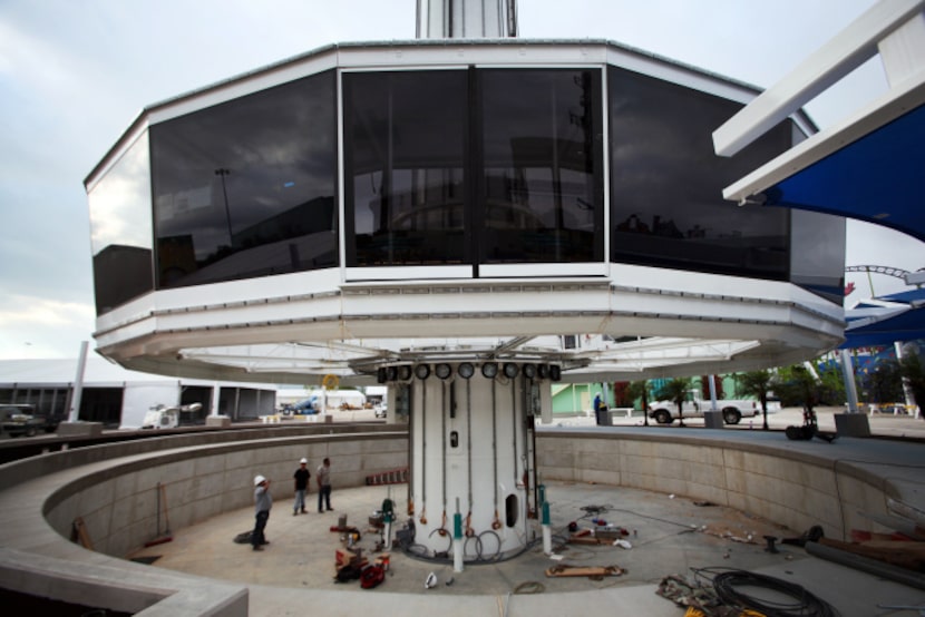 A passenger gondola is lowered for repairs on the 500-foot Top O' Texas Tower part of Summer...