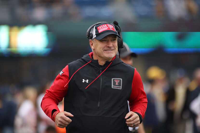 Texas Tech head coach Joey McGuire runs on to the field during the first half of an NCAA...