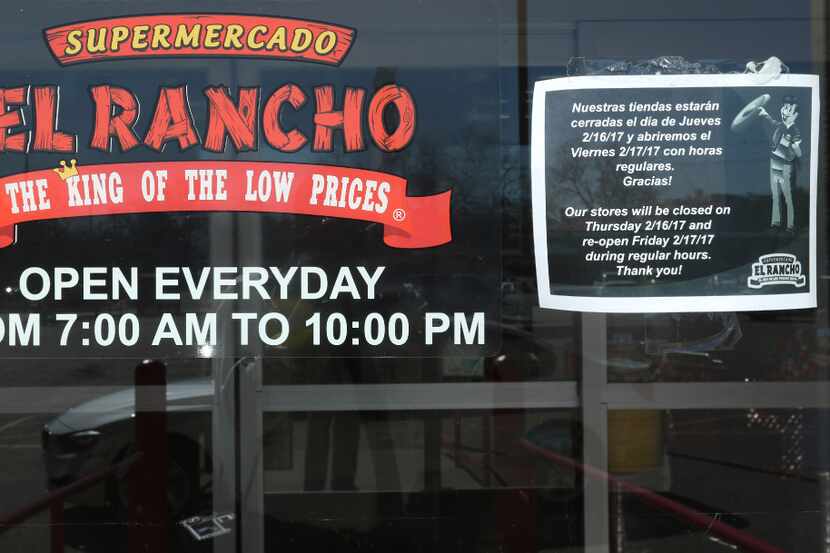 A sign, in English and Spanish, on the door of Supermercado El Rancho, on 4121 Gaston Ave.,...