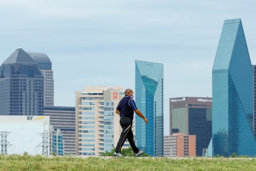 A file photo shows a man walking along the Trinity Levee Trail on Wednesday, Aug. 18, 2021,...