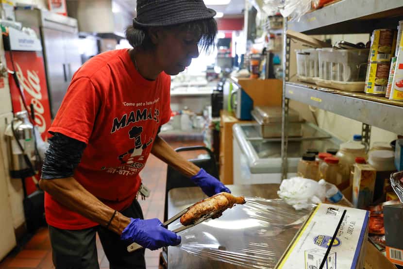 Ernestine Edmond, owner and pitmaster of Mama E's BBQ and Home Cooking, wraps a piece of...