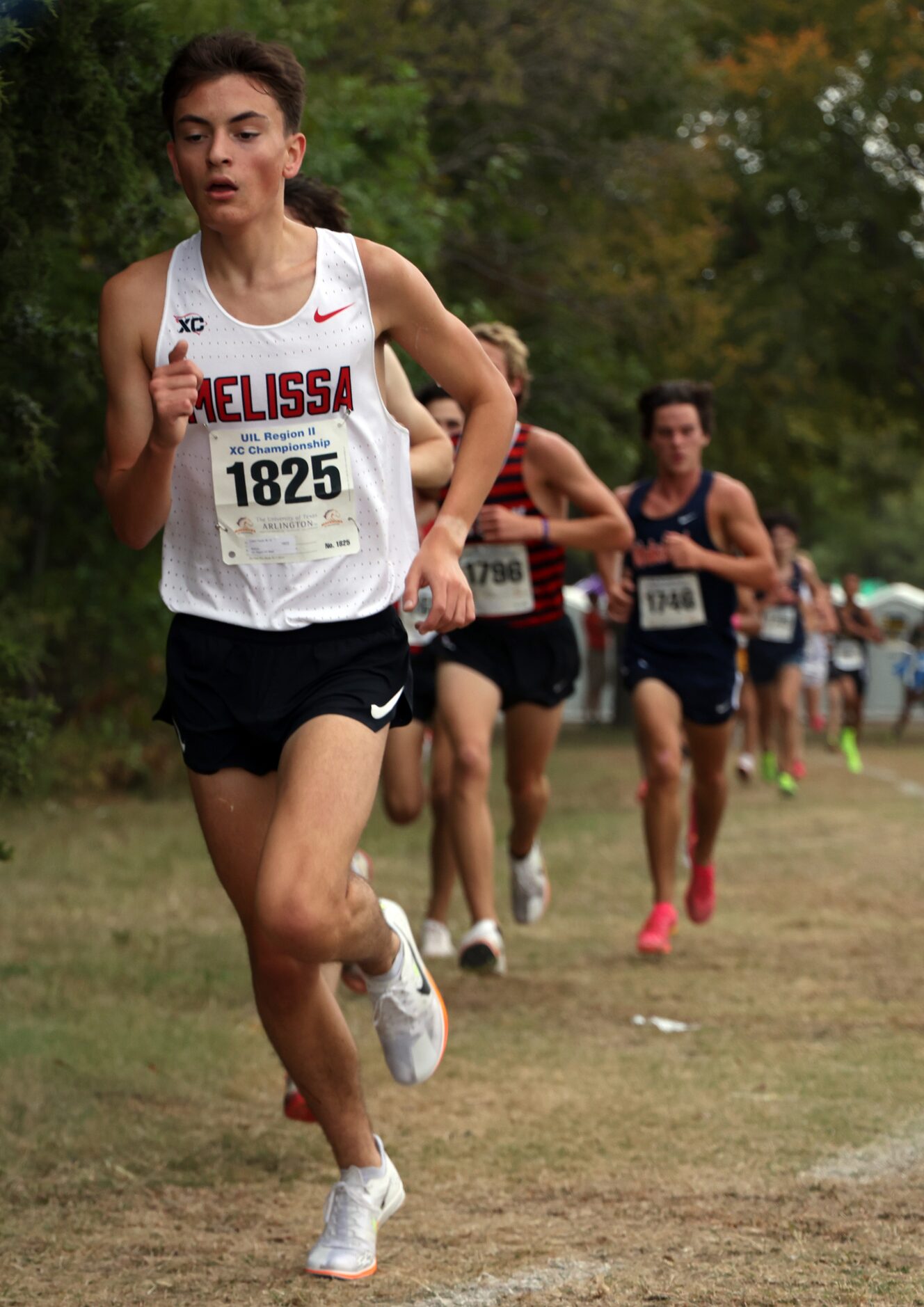 Melissa senior Logan Tauch (1825) passes the midpoint leading a group of runners in the Boys...