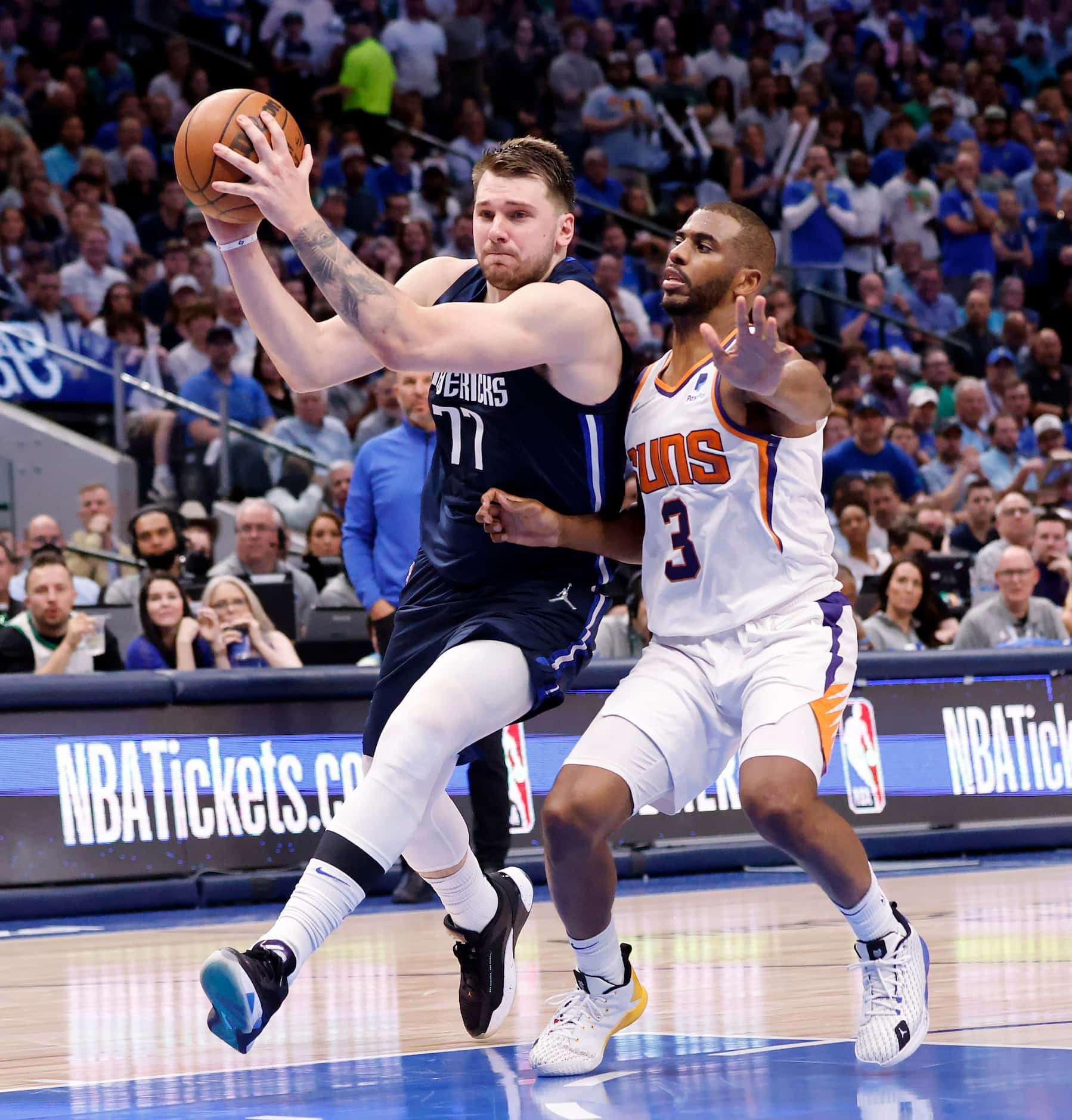 Dallas Mavericks guard Luka Doncic (77) drives strong to the basket past Phoenix Suns guard...