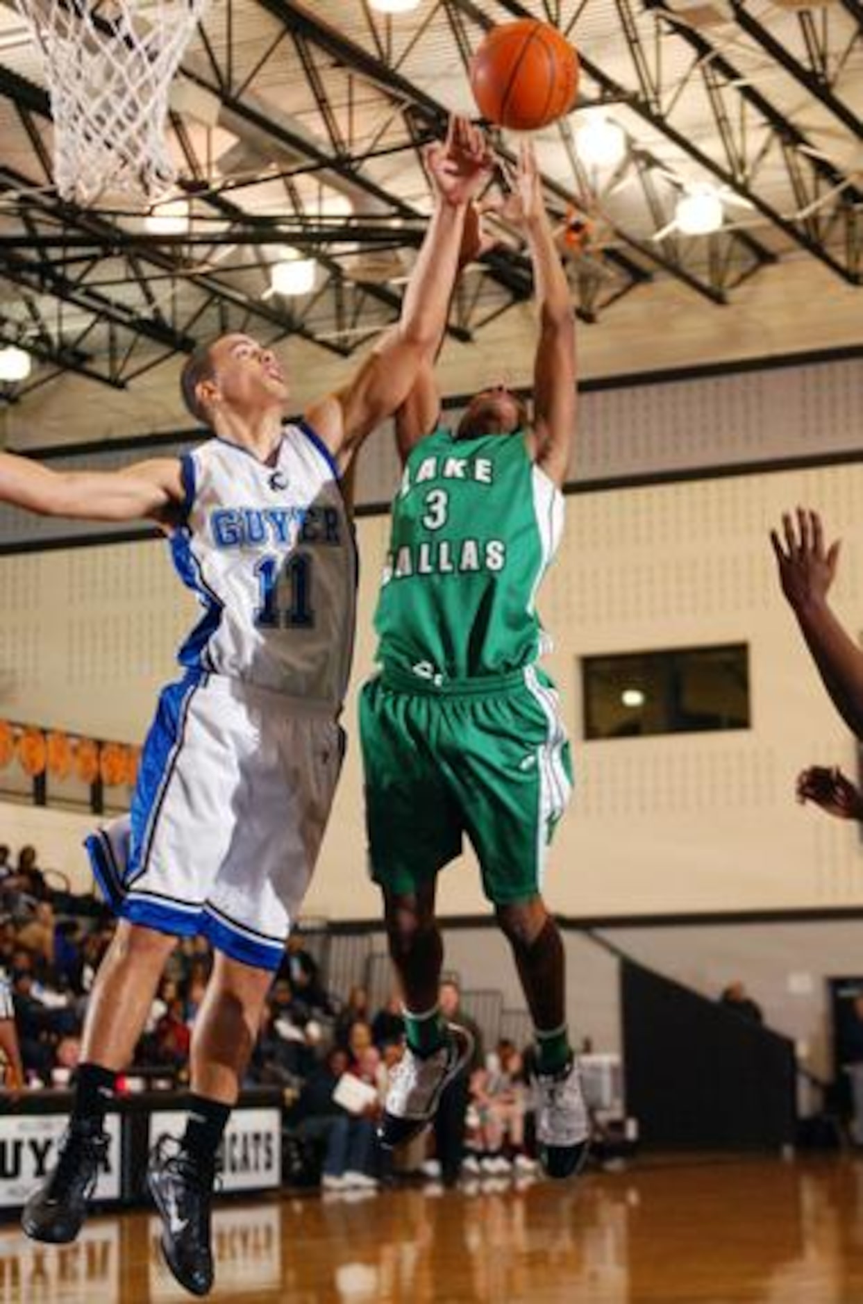 Lake Dallas' Trey Dickerson (3) grabs a rebound before Guyer's Mike Pospieski (11) on...