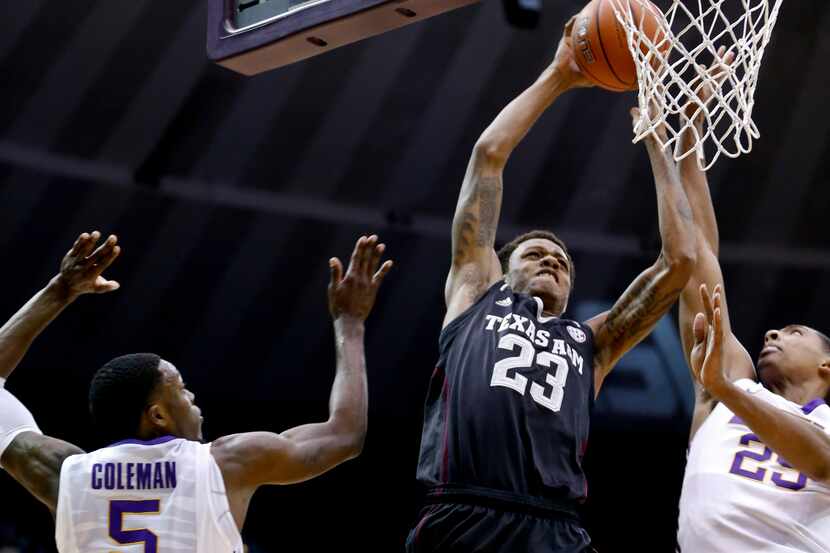 LSU Tigers forward Jordan Mickey (25) goes up to block a dunk by Texas A&M Aggies guard...