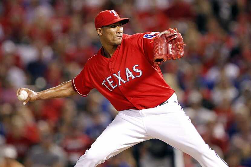 Texas Rangers relief pitcher Alexi Ogando (41) throws against the Tampa Bay Rays in the...