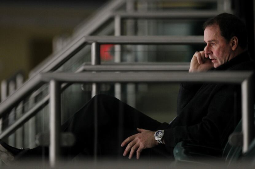 Dallas Stars general manager Joe Nieuwendyk talks on the phone during a break in a scrimmage...