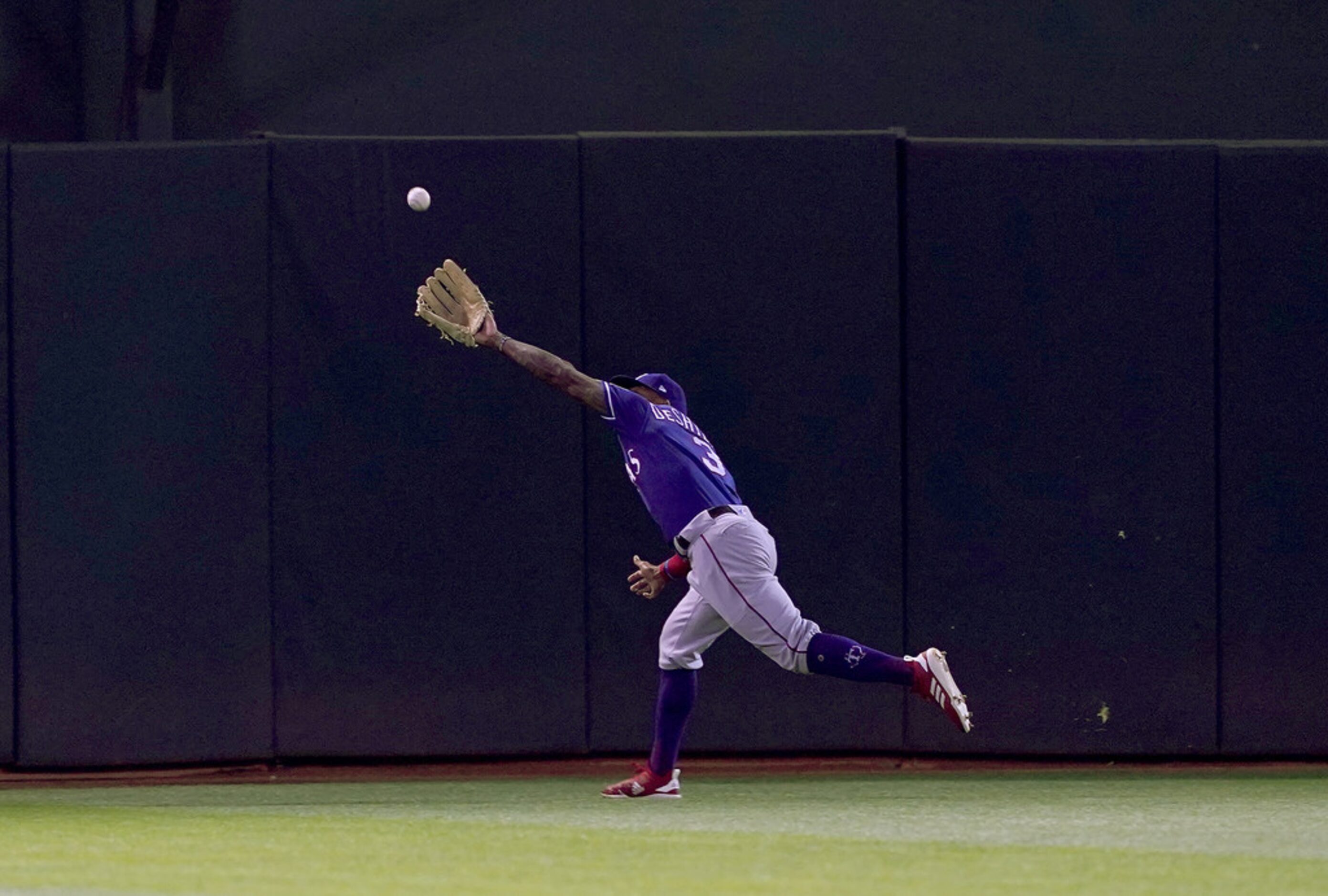 OAKLAND, CA - APRIL 22:  Delino DeShields #3 of the Texas Rangers runs down a fly ball...