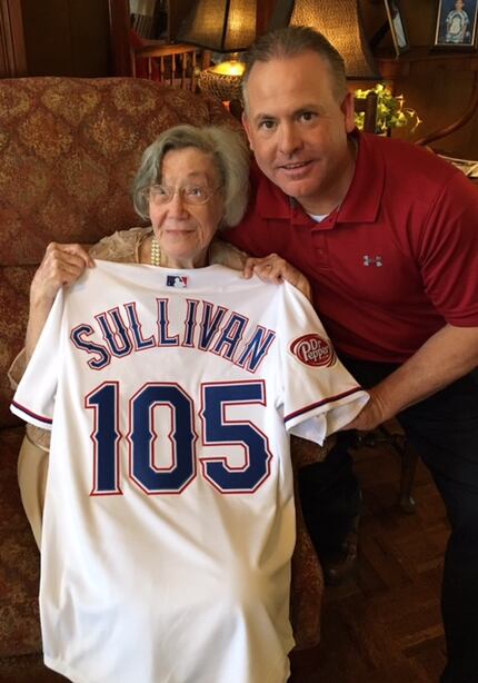  Elizabeth Sullivan holds her custom Rangers jersey presented to her by Kirk Conger....