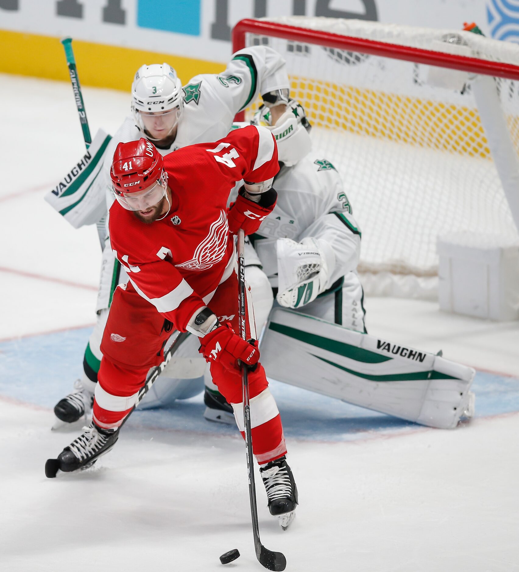 Detroit Red Wings forward Luke Glendening (41) deflects a shot past Dallas Stars defenseman...