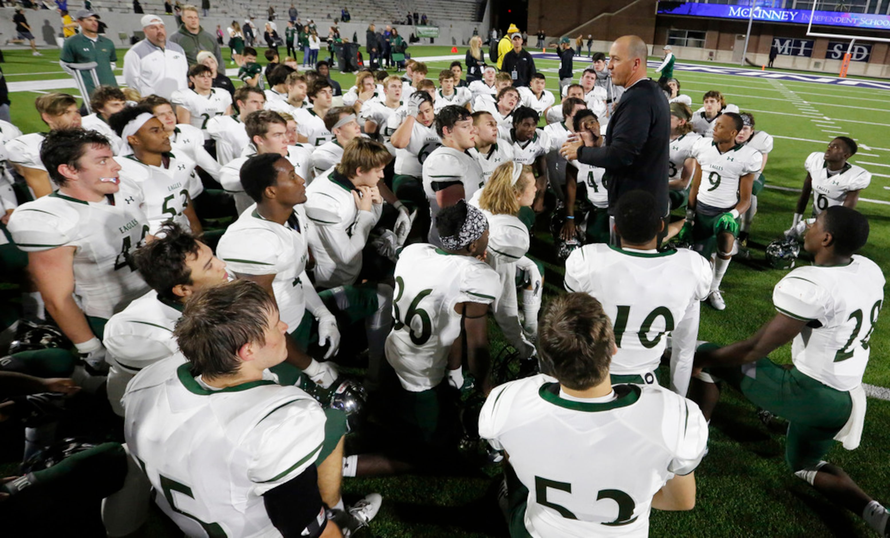 Prosper head coach Brandon Schmidt talks with his players on the field after their 42-37 win...