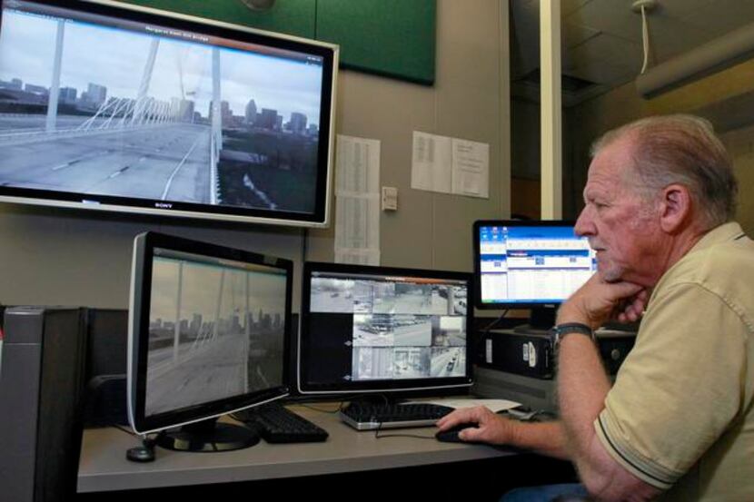 Ron Stewart of the Dallas Police Department monitors security cameras on the bridge from...