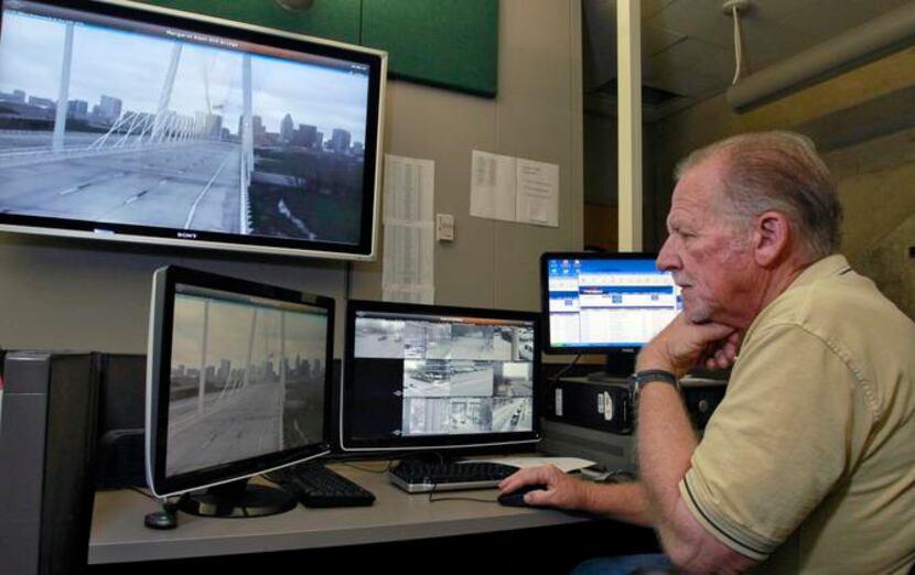 Ron Stewart of the Dallas Police Department monitors security cameras on the bridge from...