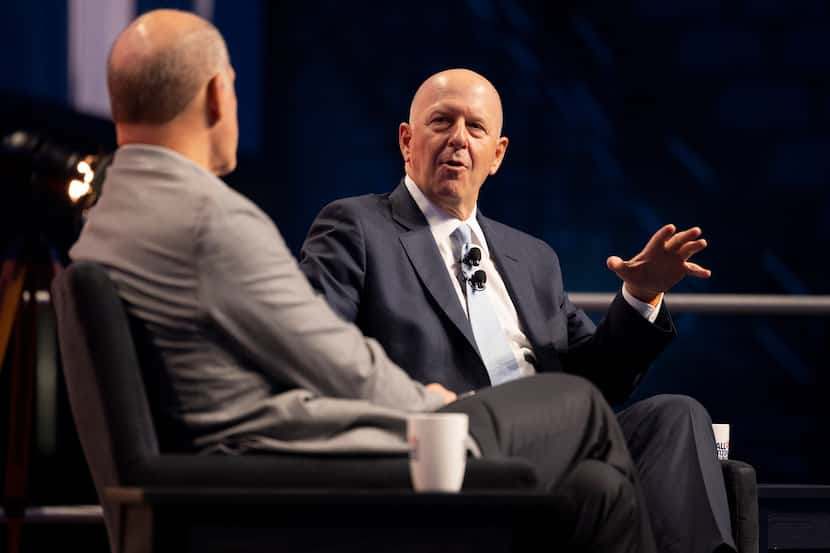 Goldman Sachs CEO David Solomon has a conversation with AT&T CEO John Stankey (left) at the...