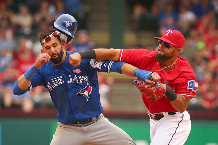 Toronto Blue Jays Jose Bautista (19) gets hit by Texas Rangers second baseman Rougned Odor...