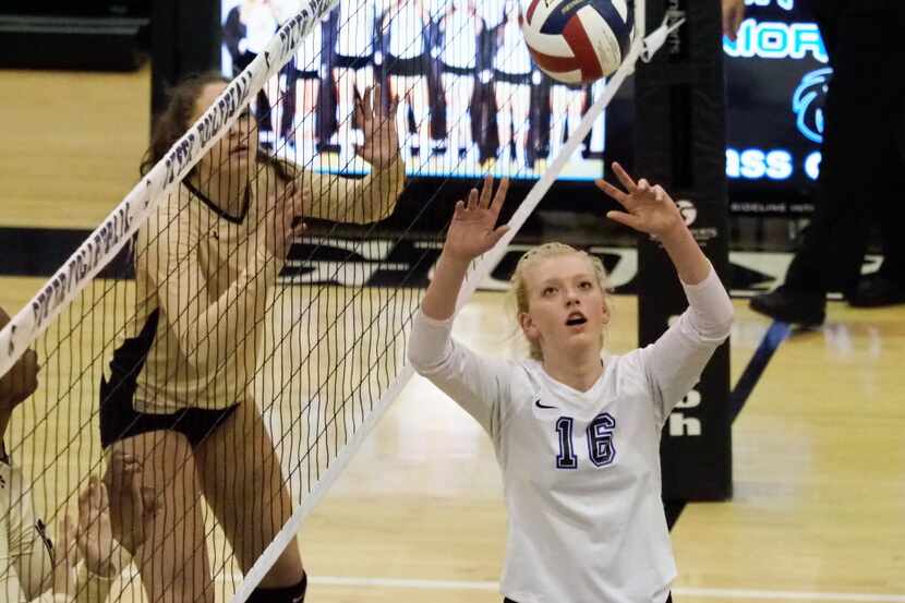 Guyer freshman Brooke Slusser (16) sets up a teammate for a spike attempt against the Plano...