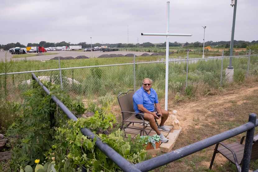 Jay Hasbrouck sits near one of his crosses he is erecting as part of his new Faith United...