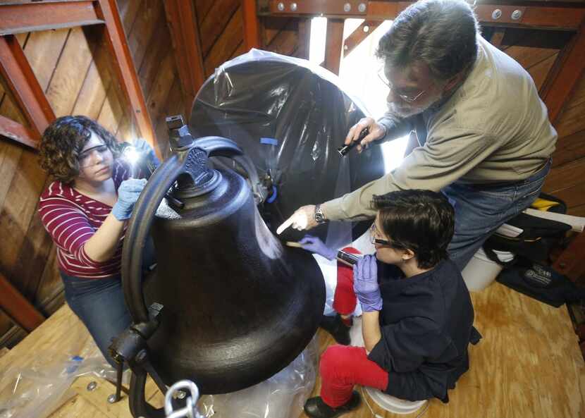Conservators  work on a bell in the tower of the First Baptist Church, which was founded by...