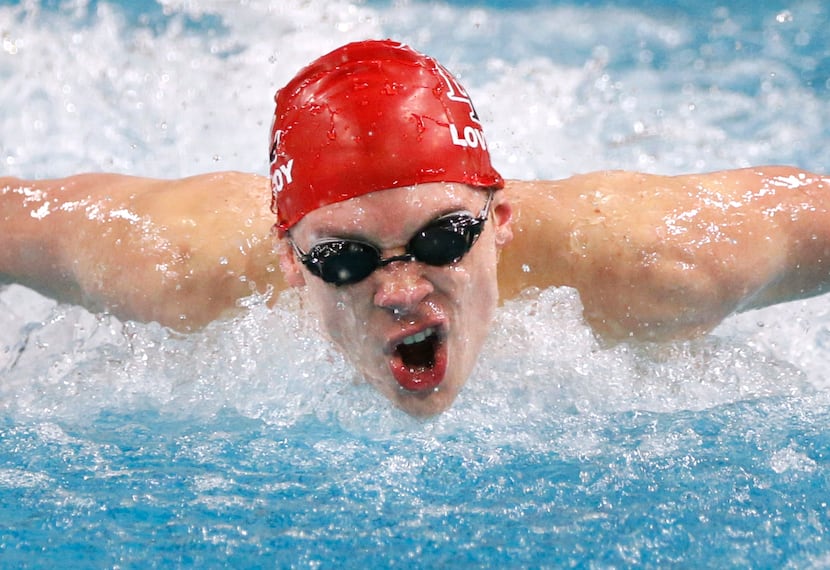 Lucas Lovejoy swimmer James Vaughn swims the boys 100 yard butterfly championship during the...