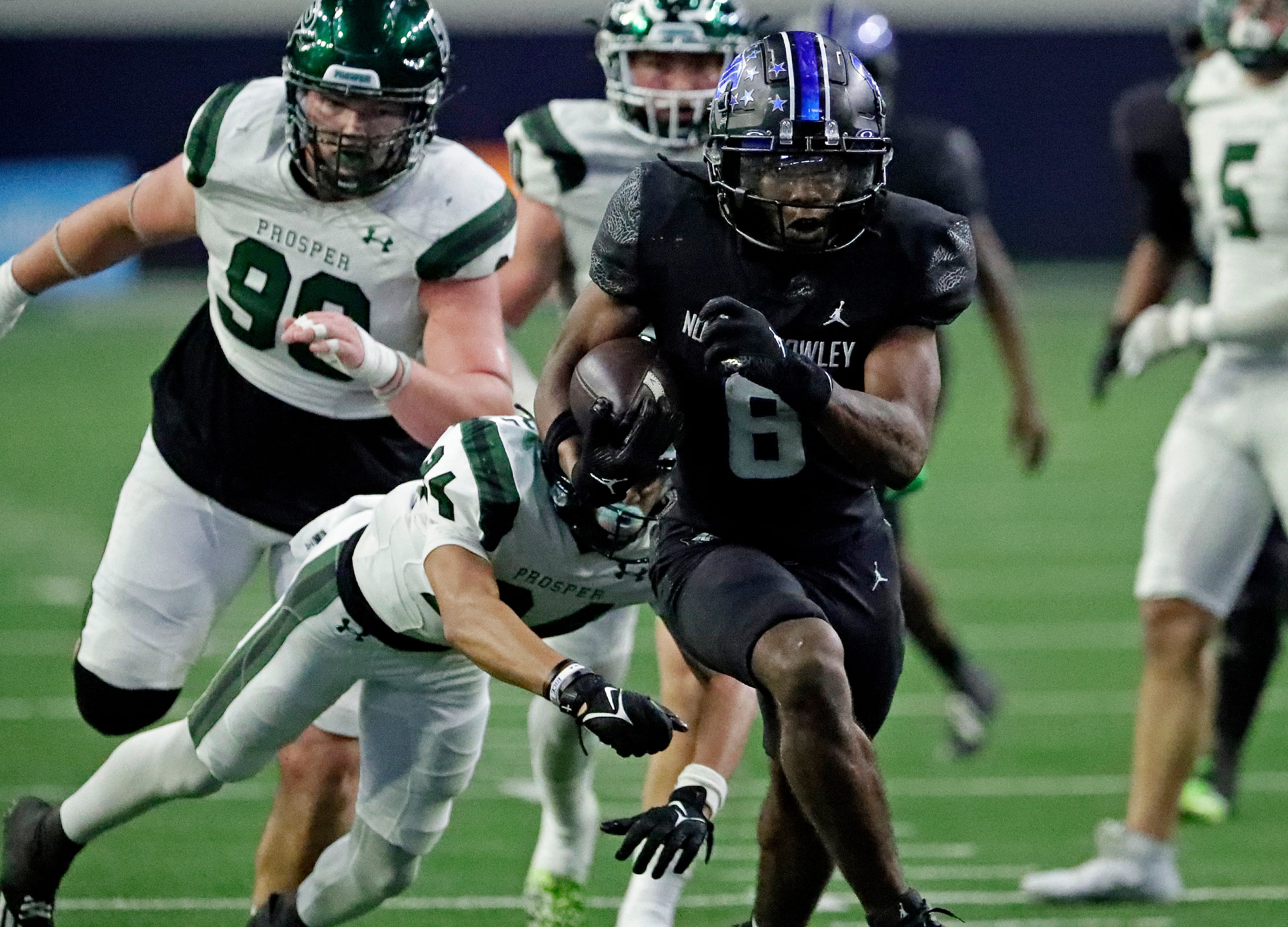 North Crowley High School running back Ashton Searl (8) runs through a tackle attempt by...