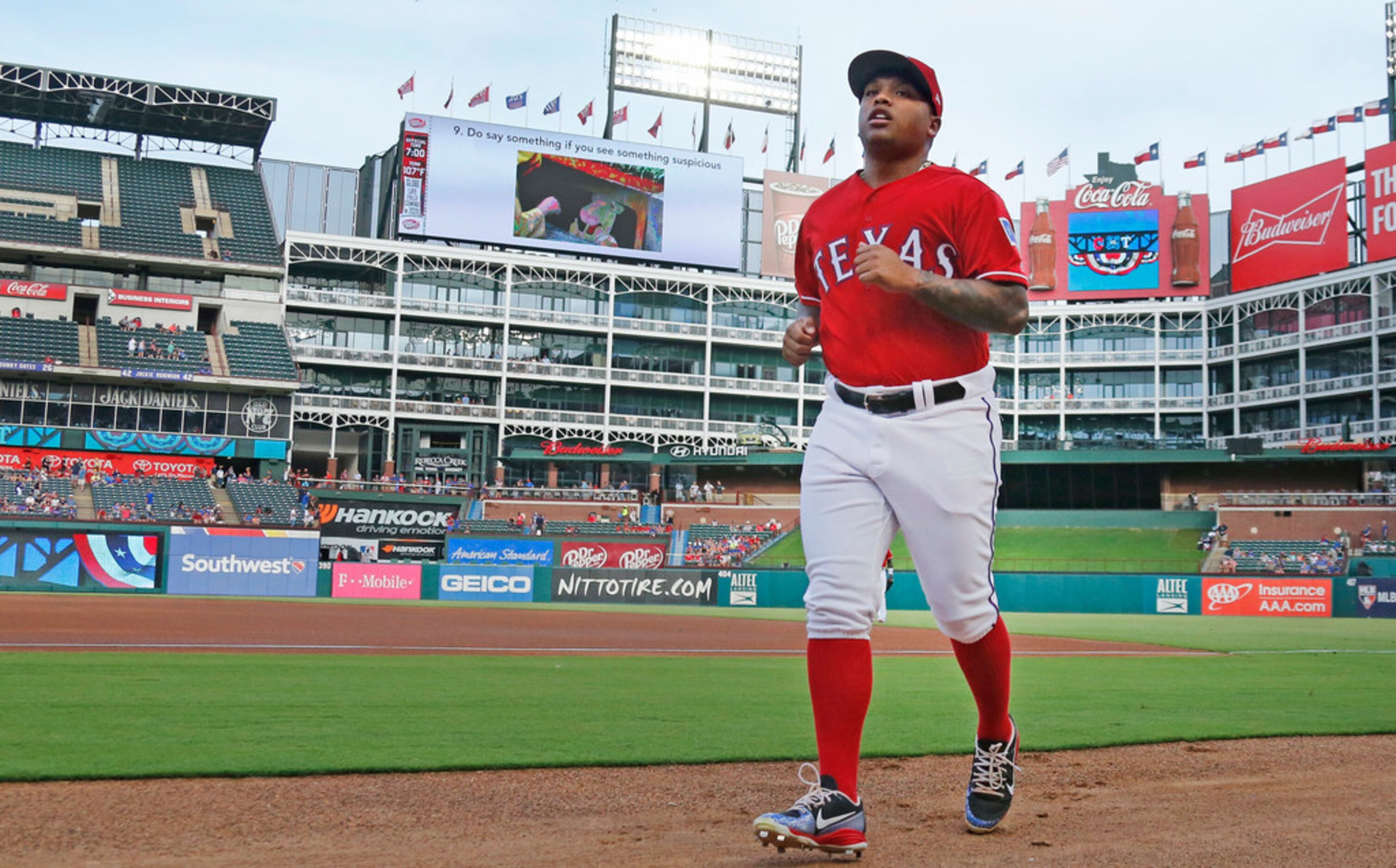 Texas Rangers designated hitter Willie Calhoun (5) heads to the dugout after warming up in...