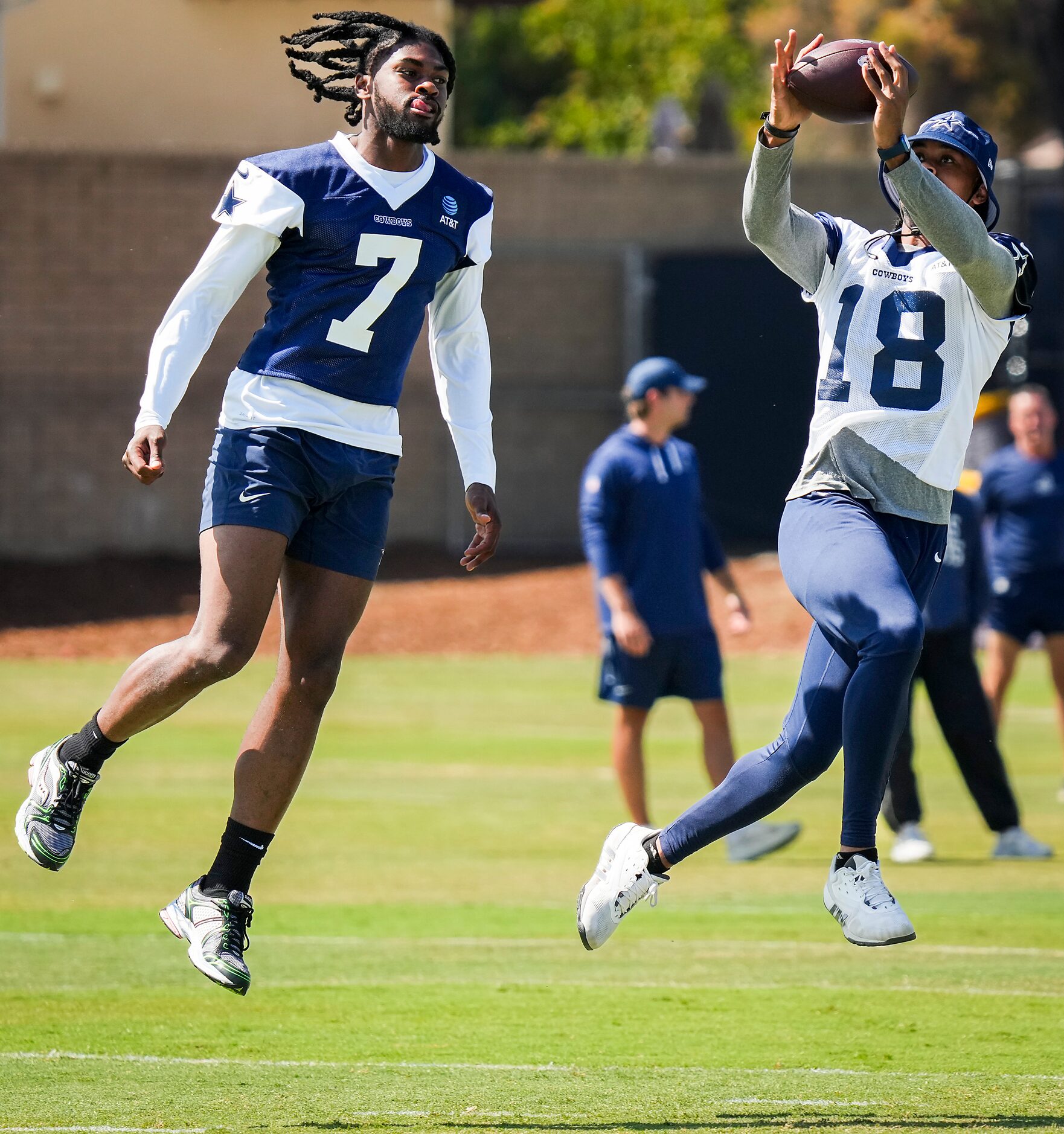 Dallas Cowboys wide receiver Jalen Tolbert (18) makes a catch past cornerback Trevon Diggs...