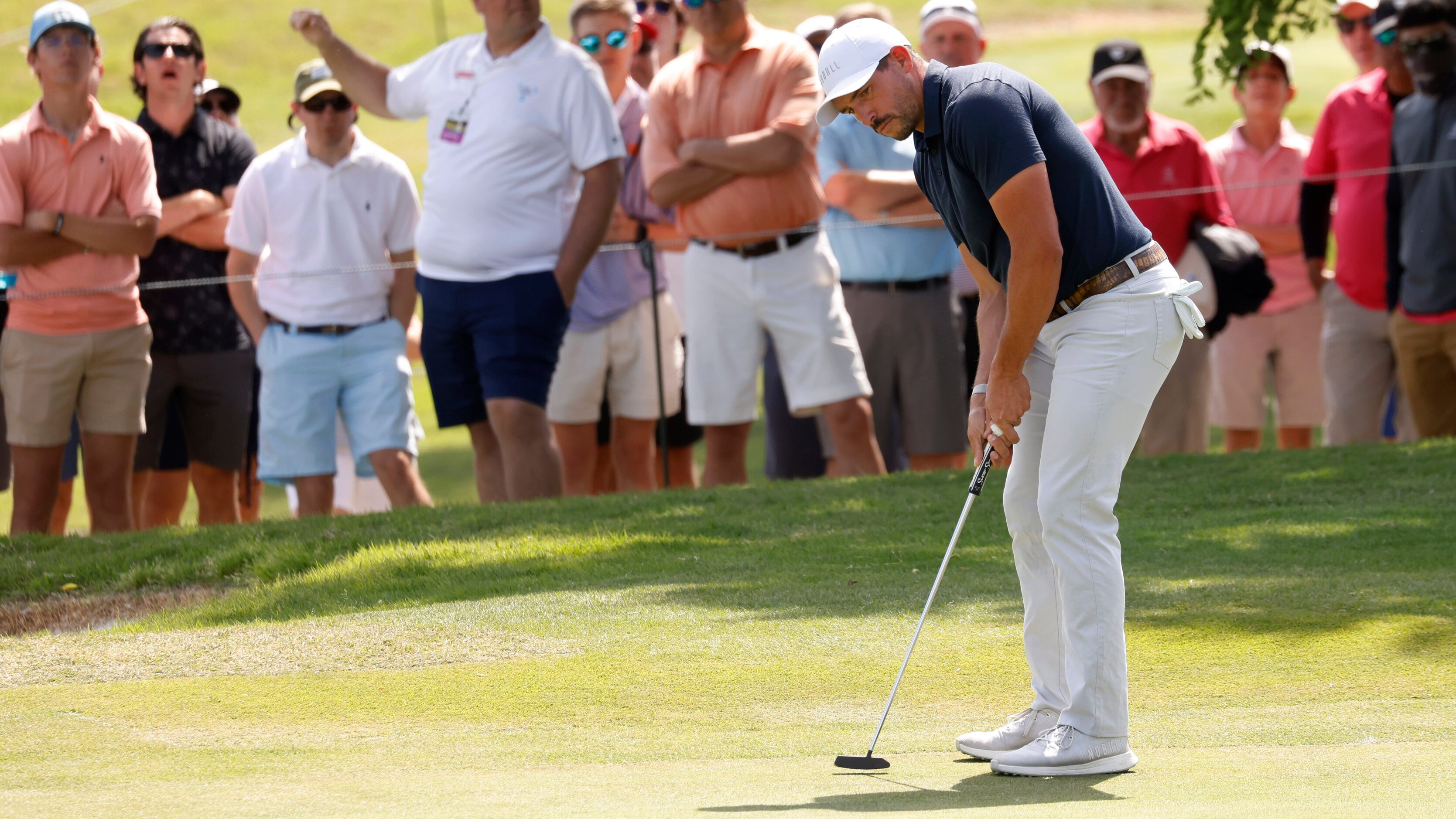 Scott Stallings watches his ball just miss on a chance for birdie on the 18th hole during...