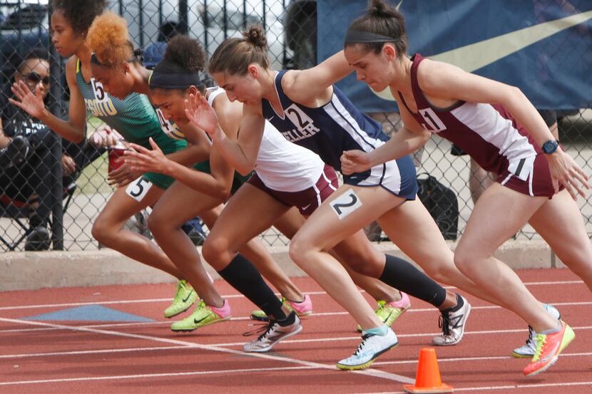 Runners lean into the first step of the Girls 800 Meter Run event. The Jesuit-Sheaner Relays...
